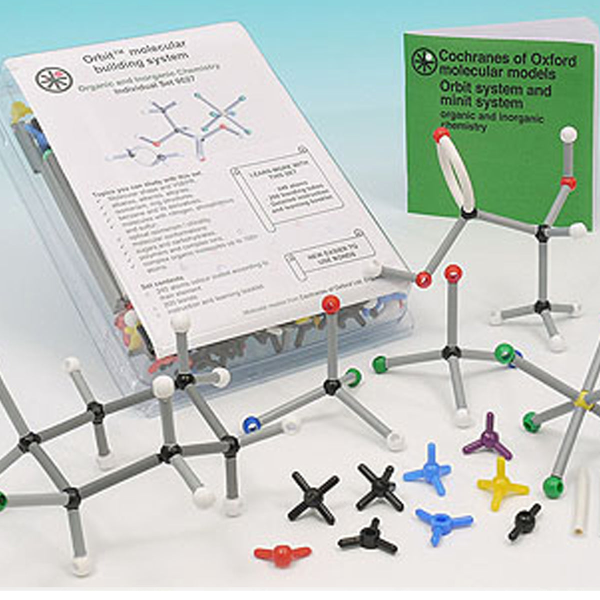 Molecular modeling set with orbitals and instructional materials on a white background